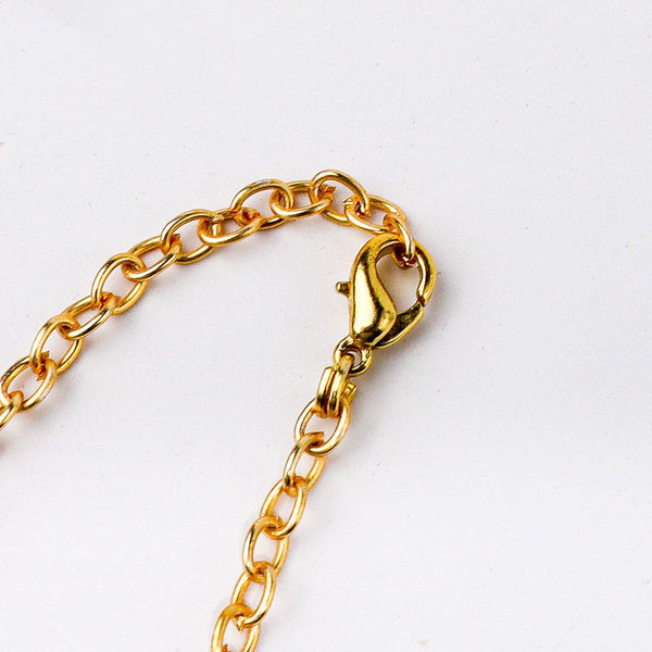Angled view of a 22K gold-plated fashion chain highlighting its unique structure, elegant links, and polished gold finish