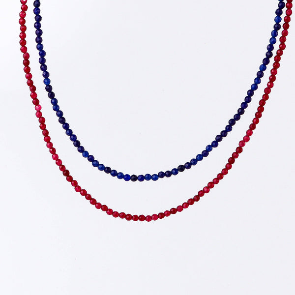 Flat-lay of a fashion necklace with complementary jewellery and accessories for a chic styling setup