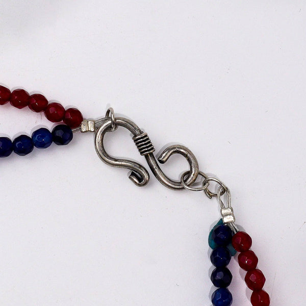 Angled view of a fashion necklace highlighting its unique silhouette, elegant structure, and polished finish