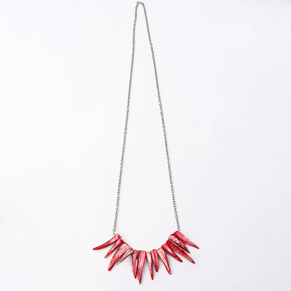 Detailed view of the fashion necklace highlighting intricate motifs, textured detailing, and smooth jewelry finish