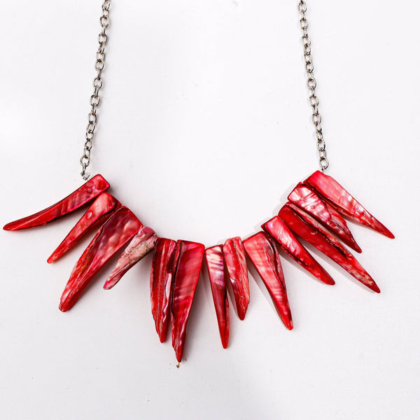 Angled view of the fashion necklace highlighting its unique silhouette, structure, and polished finish
