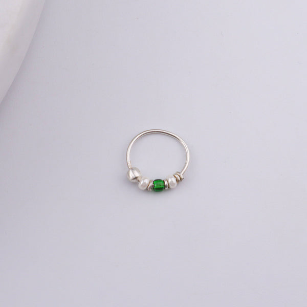 Angled view of Silver Septum Cum Nose Ring with green and white beads and a polished 92.5 sterling silver finish