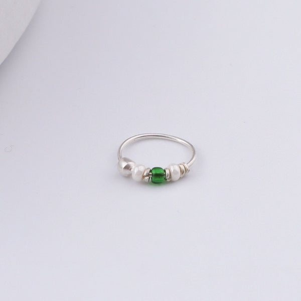 Close-up of Silver Septum Cum Nose Ring showcasing intricate silverwork with green and white bead detailing