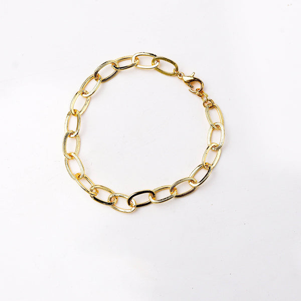 Detailed view of a 22K gold-plated fashion bracelet highlighting intricate motifs, textured detailing, and a premium 22K gold-plated finish