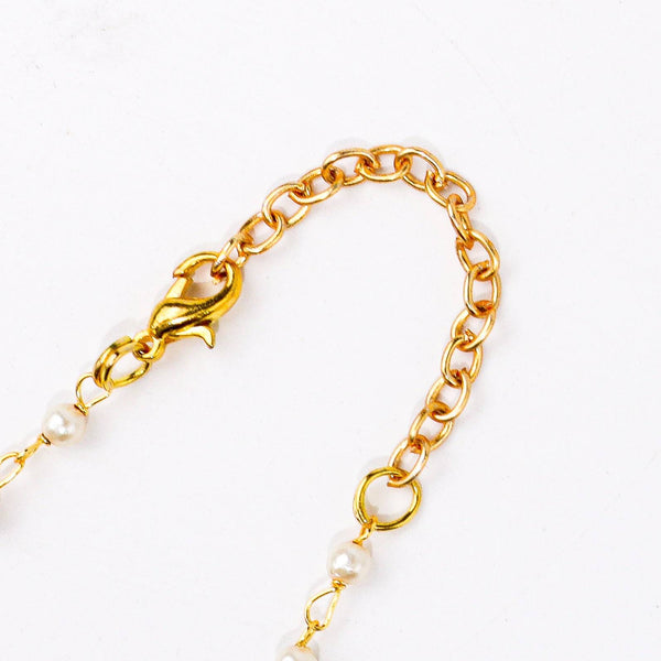 Angled view of a 22K gold-plated fashion necklace highlighting its elegant structure, unique design, and polished gold finish