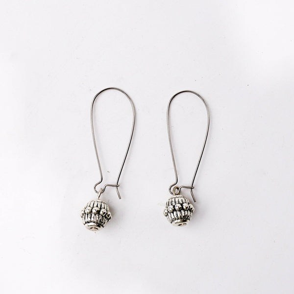 Close-up of a fashion earring showcasing intricate detailing, fine craftsmanship, and a refined finish