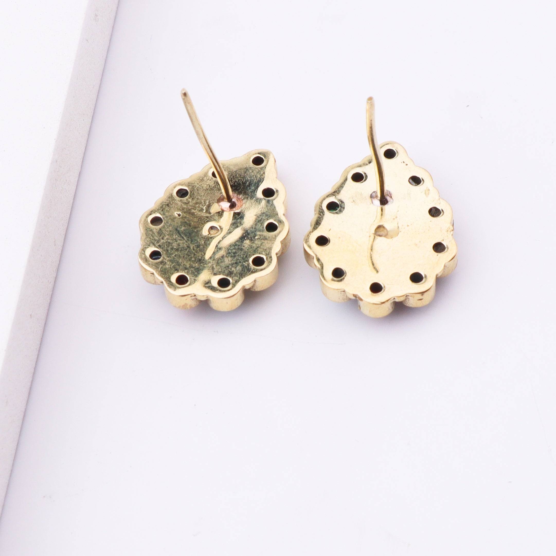 Angled view of Brass Fashion Earrings highlighting the unique silhouette, structure, and polished brass finish