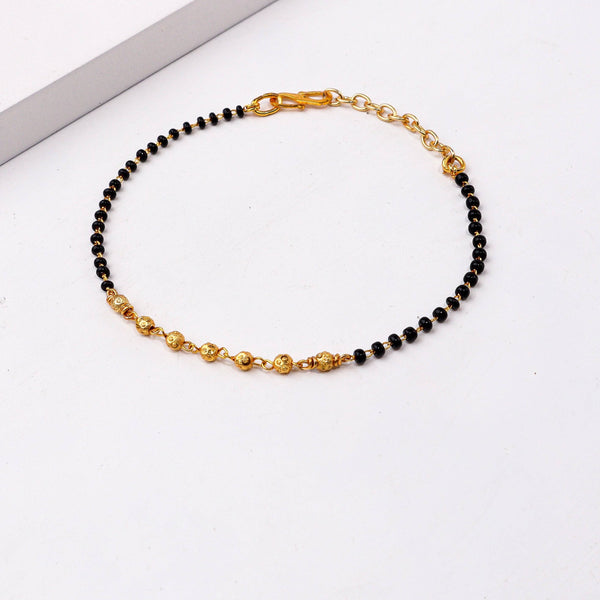 Angled view of 22K gold-plated fashion mangalsutra bracelet highlighting its unique structure, elegant silhouette, and polished gold finish