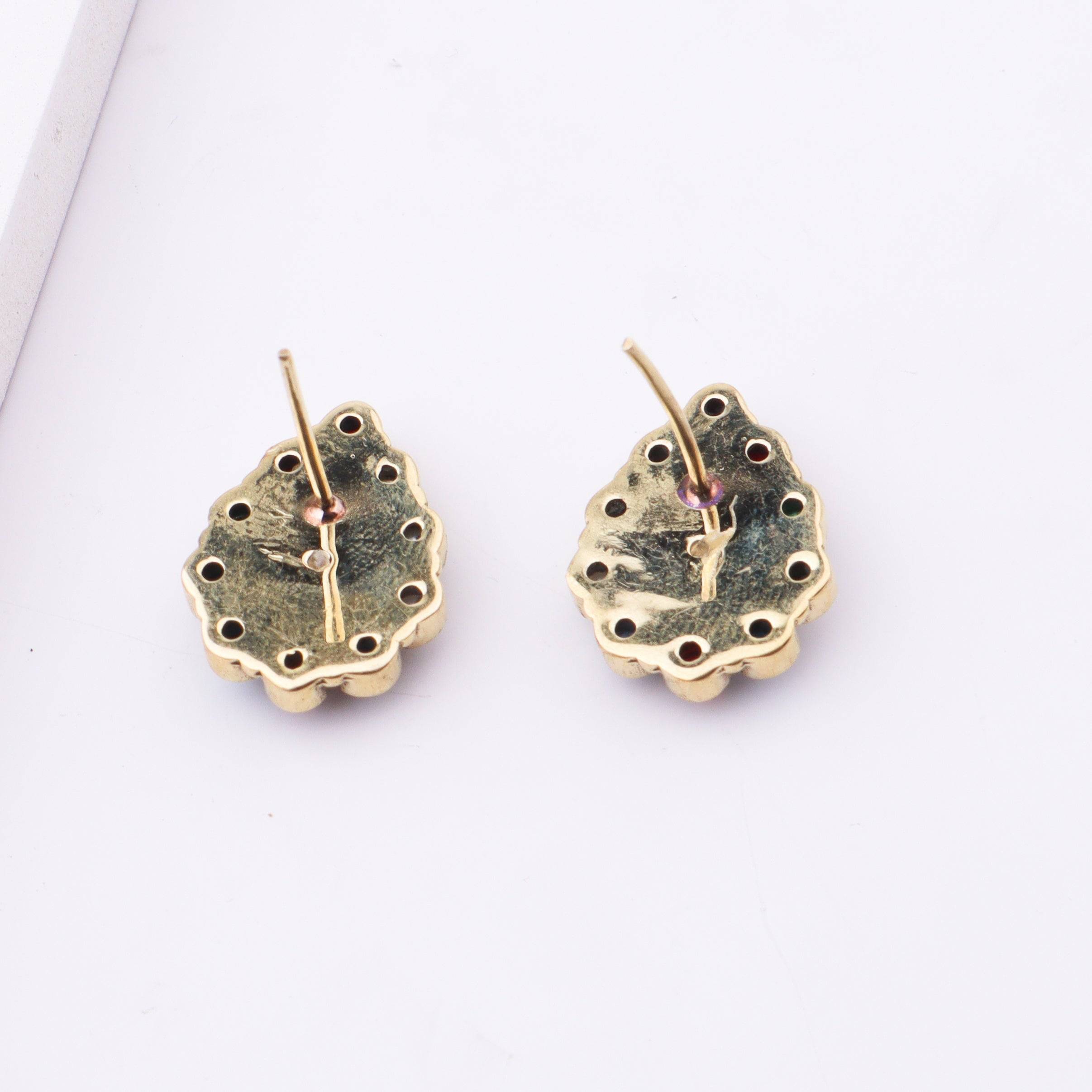 Angled view of Brass Fashion Earrings highlighting the unique silhouette, structure, and polished brass finish