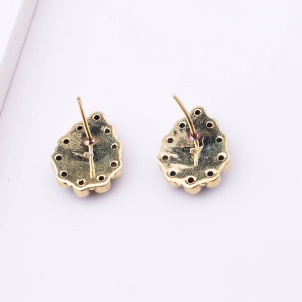 Angled view of Brass Fashion Earrings highlighting the unique silhouette, structure, and polished brass finish