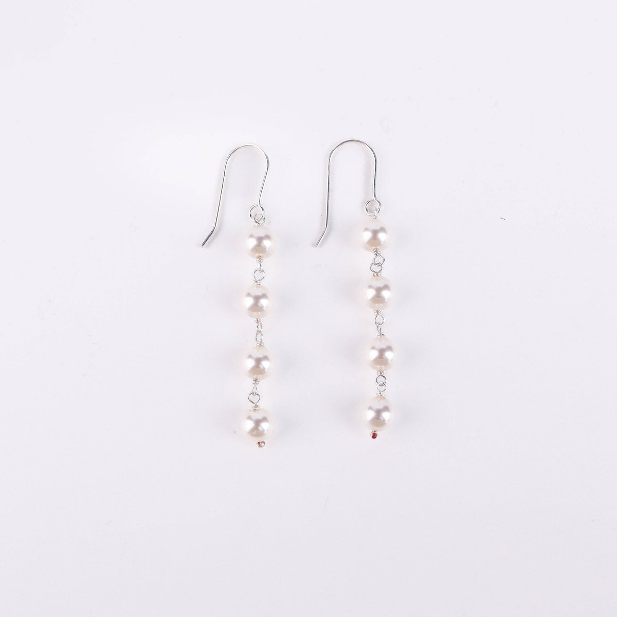 Angled side view of Pearl Dangling Earring in silver