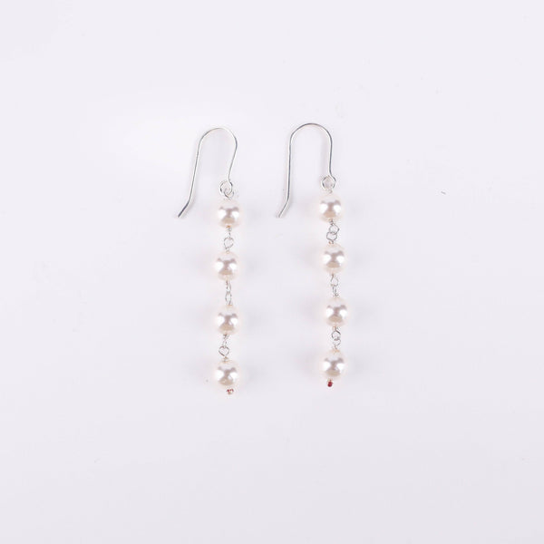 Angled side view of Pearl Dangling Earring in silver