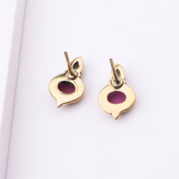 Angled view of Brass Fashion Earrings highlighting the unique silhouette, structure, and polished brass finish