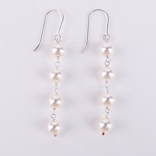 Detail shot of pearl drop and polished silver finish