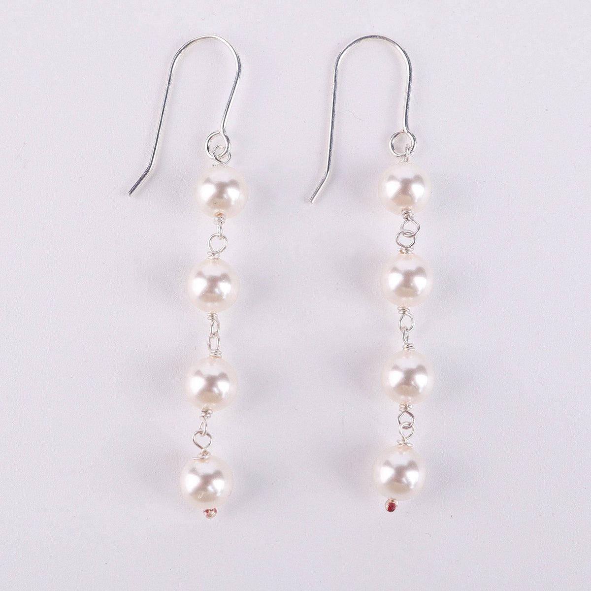 Detail shot of pearl drop and polished silver finish