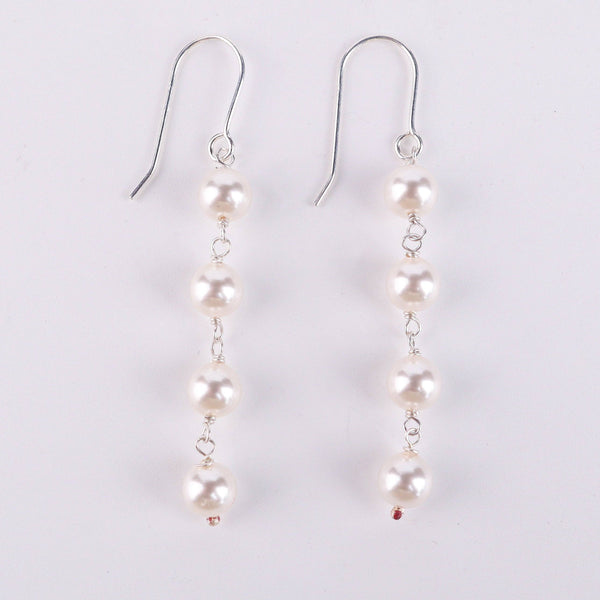 Detail shot of pearl drop and polished silver finish