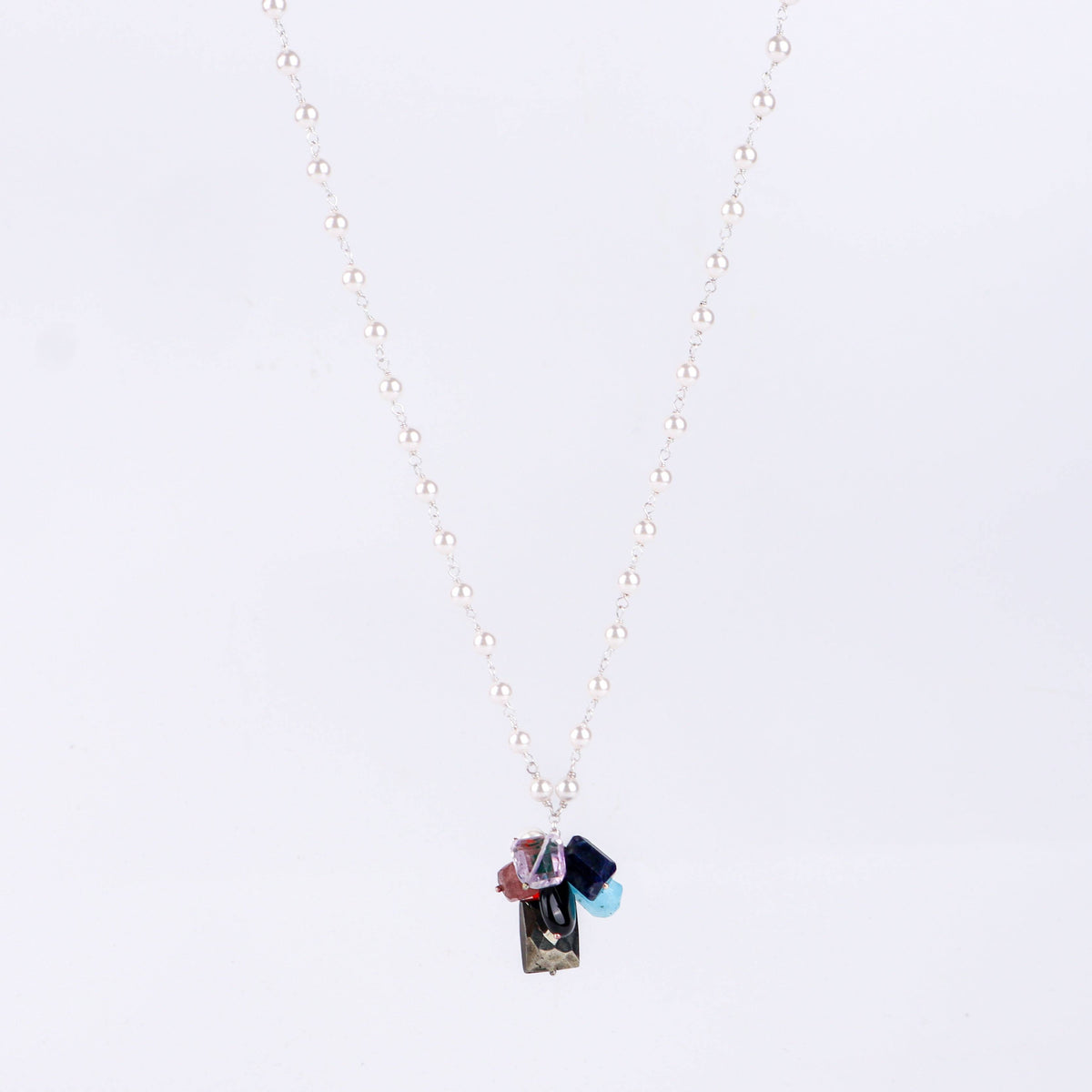 Angled side view of multicolour gemstone necklace showing layered design and silver craftsmanship