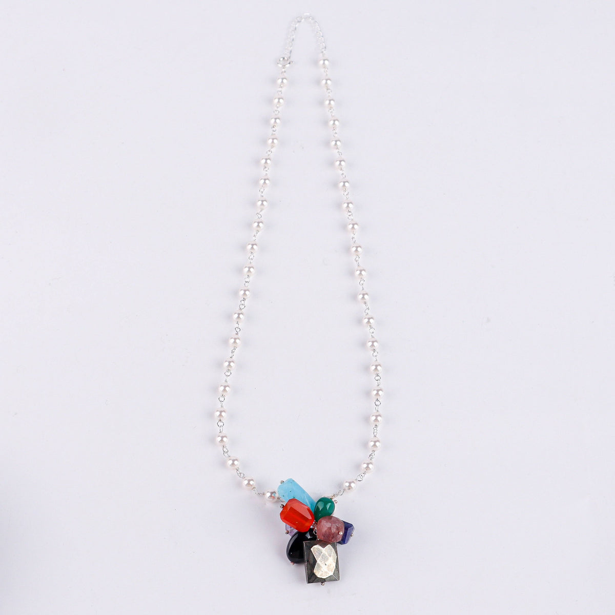 Macro detail of colorful gemstones and pearl Gantan on 92.5 sterling silver necklace