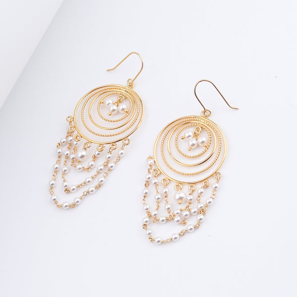 Gold and pearl chandelier earrings with layered circular design and dangling pearl chains