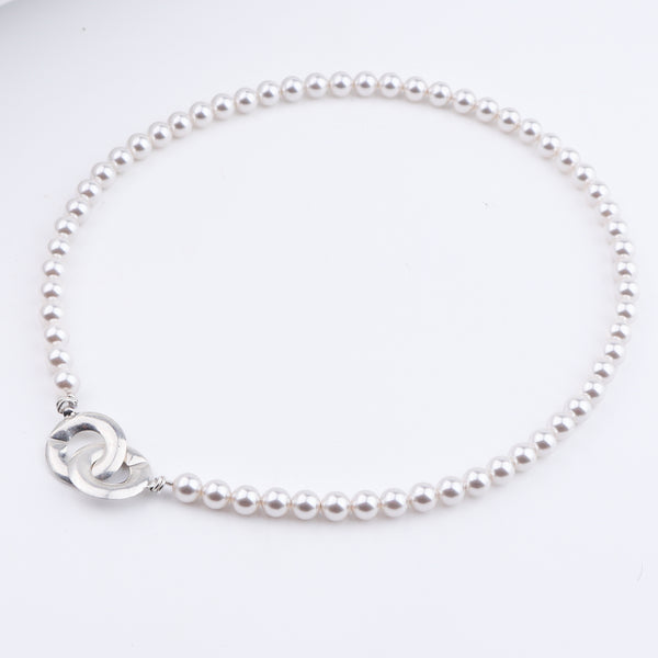 Close-up of pearl necklace with silver clasp