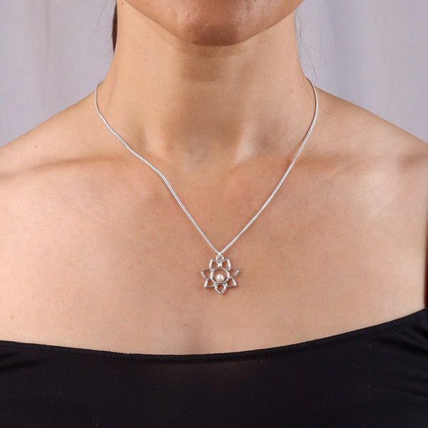 Model wearing silver chain necklace with flower pendant and pearl