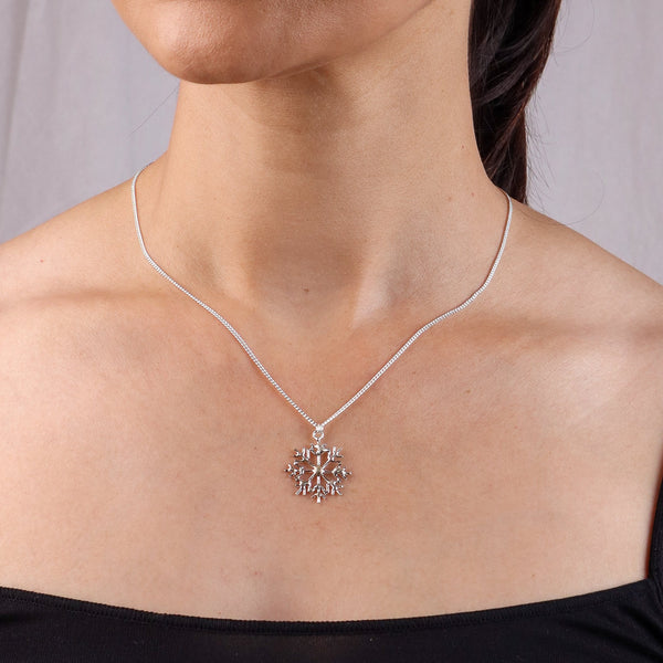 Close-up of silver necklace on model