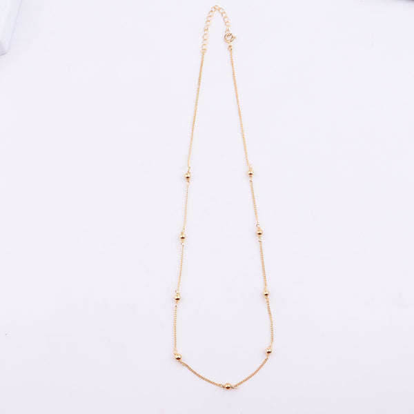 Gold chain with beads and chain detail