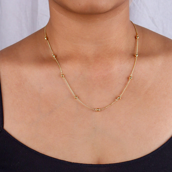 Gold beaded chain necklace on model