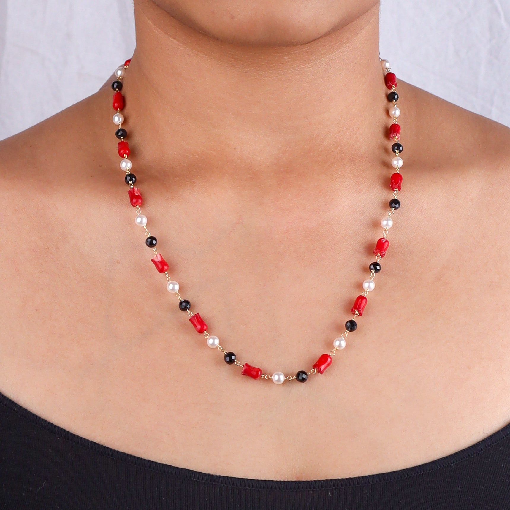 Close-up of beaded necklace on model's neck