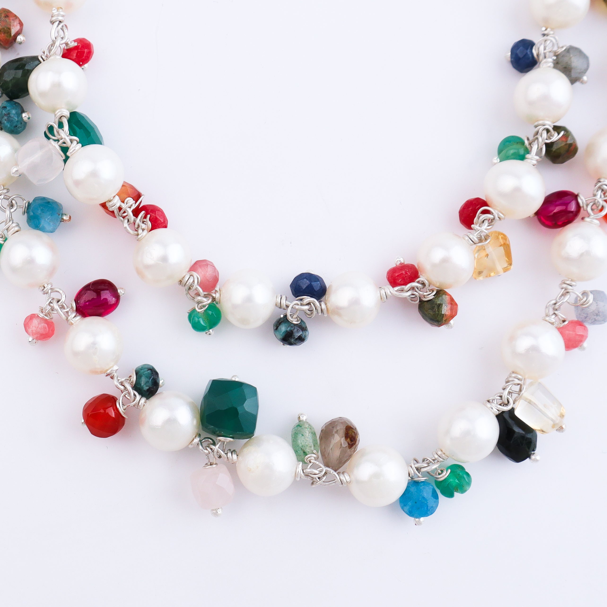 Multicolored beaded pearl necklace on white background