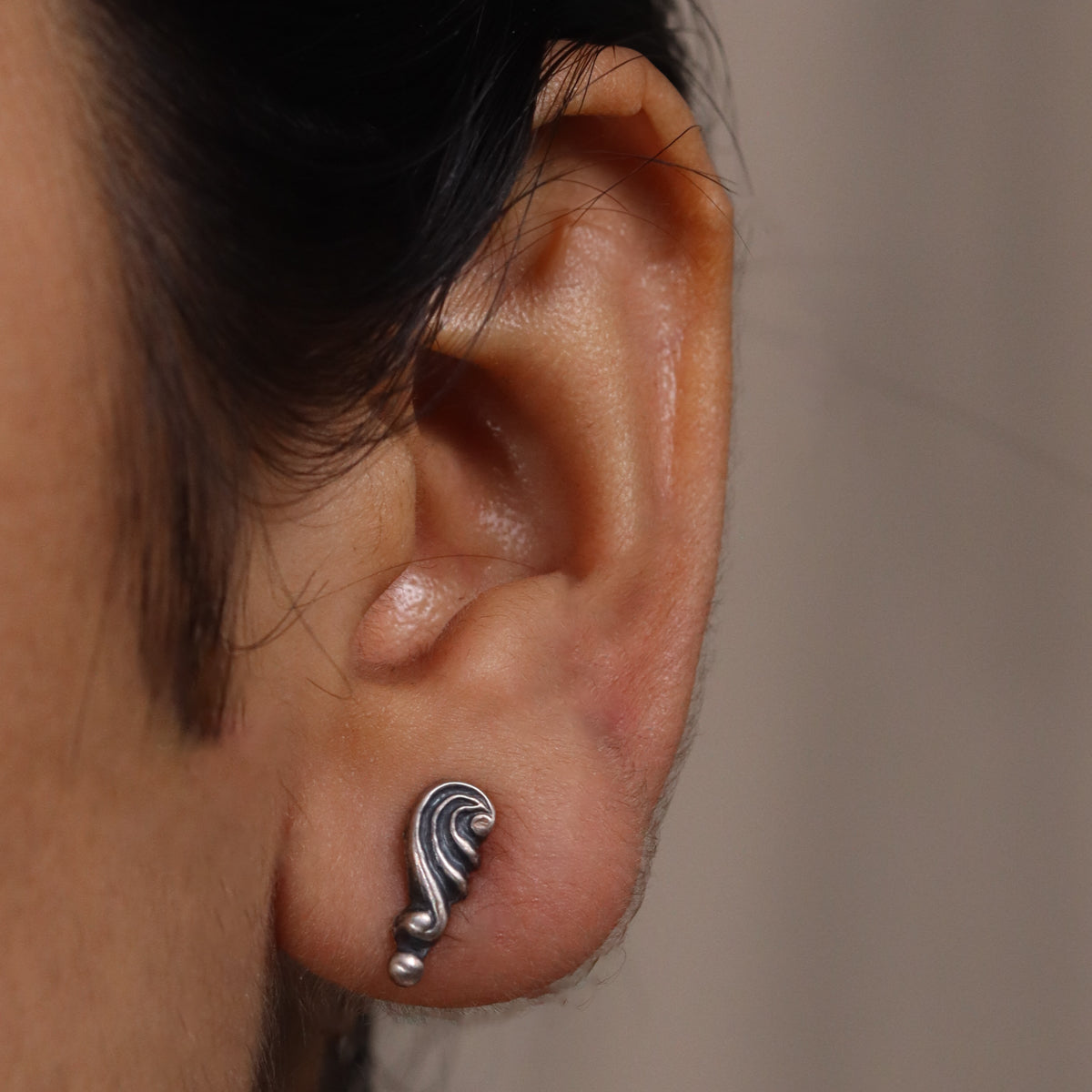 Oxidized silver shell swirl stud earrings close-up detailing
