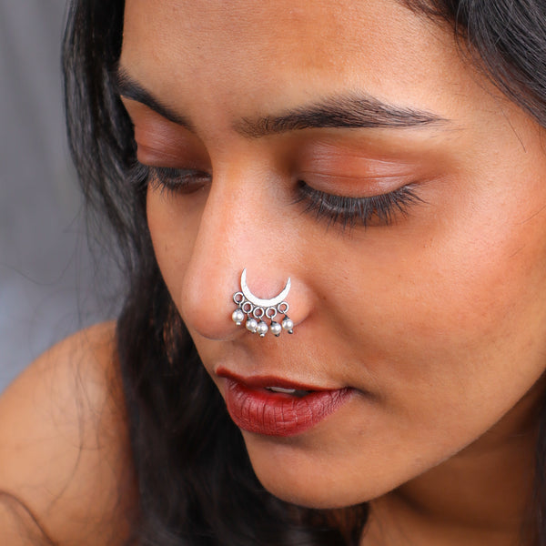 Close-up of woman with oxidised hammered Chandrakor nose pin and traditional jewelry