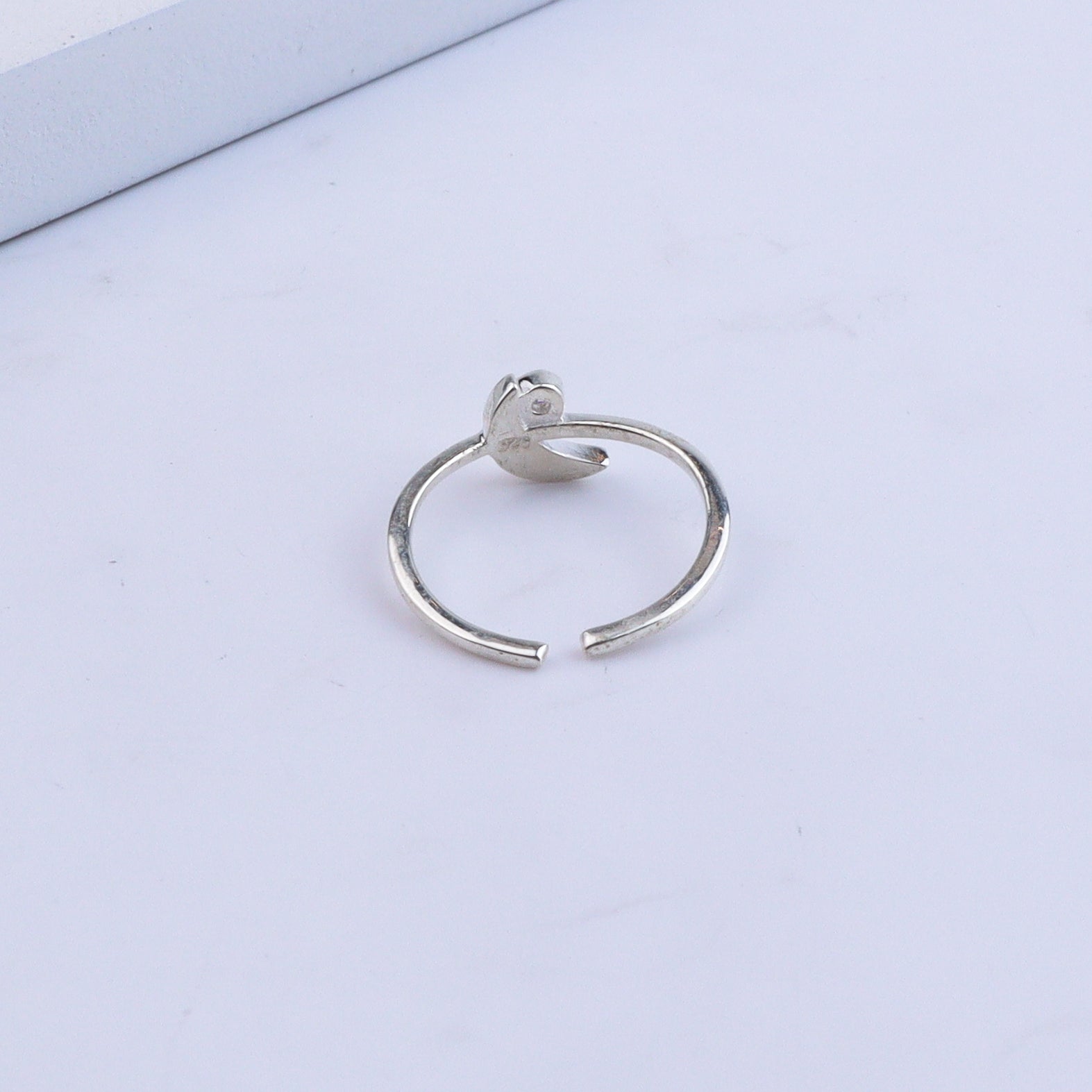 Silver ring with gemstone on white background