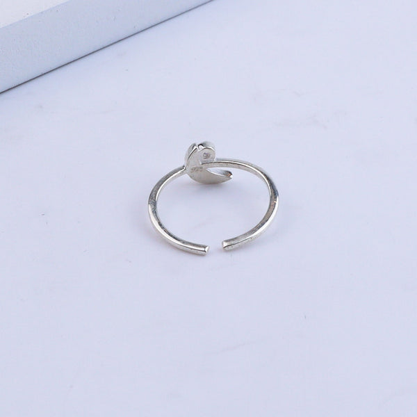 Silver ring with gemstone on white background