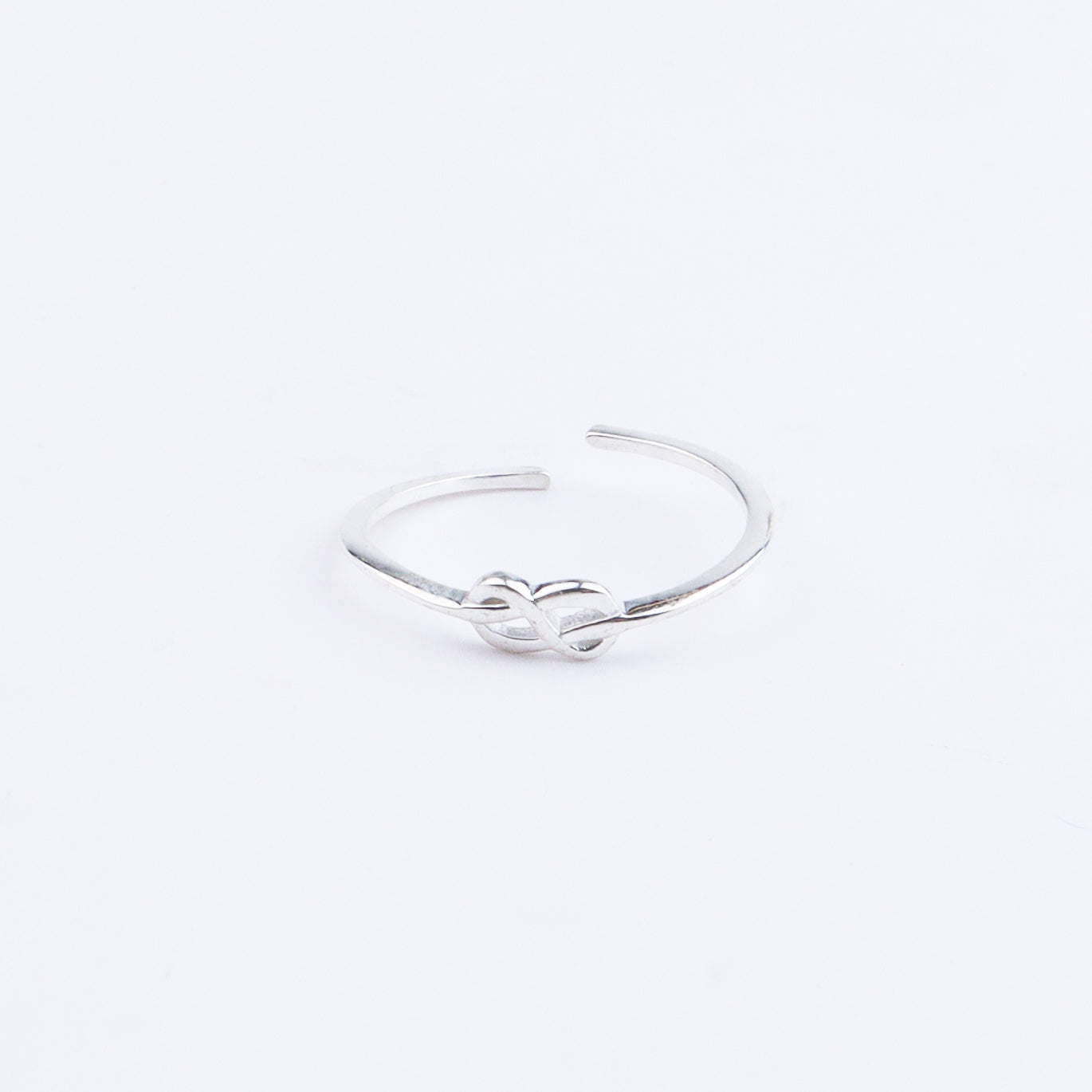 Silver infinity ring on white background