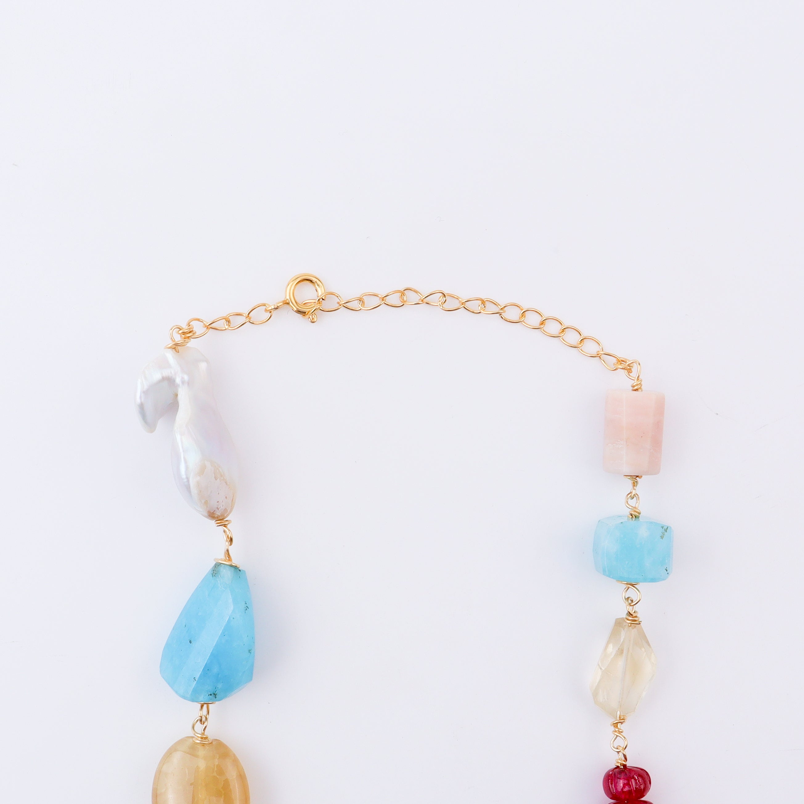 Close-up of multicolour gemstone necklace on white background