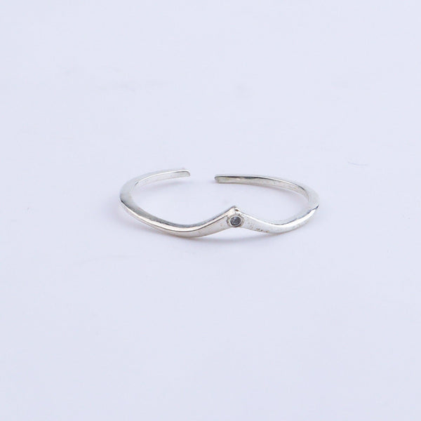 Silver open band ring on white background