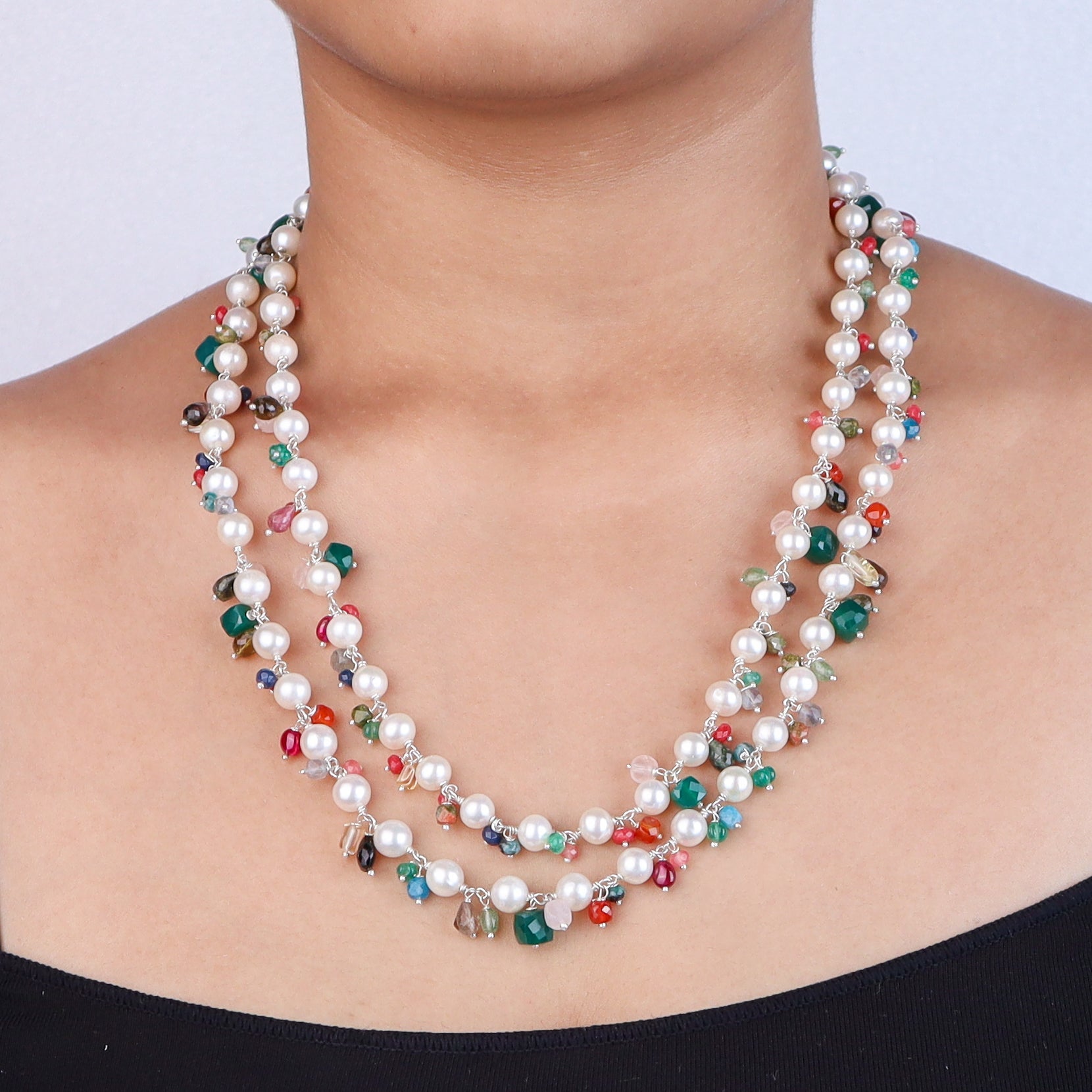 Close-up of multicolored beaded pearl necklace on model