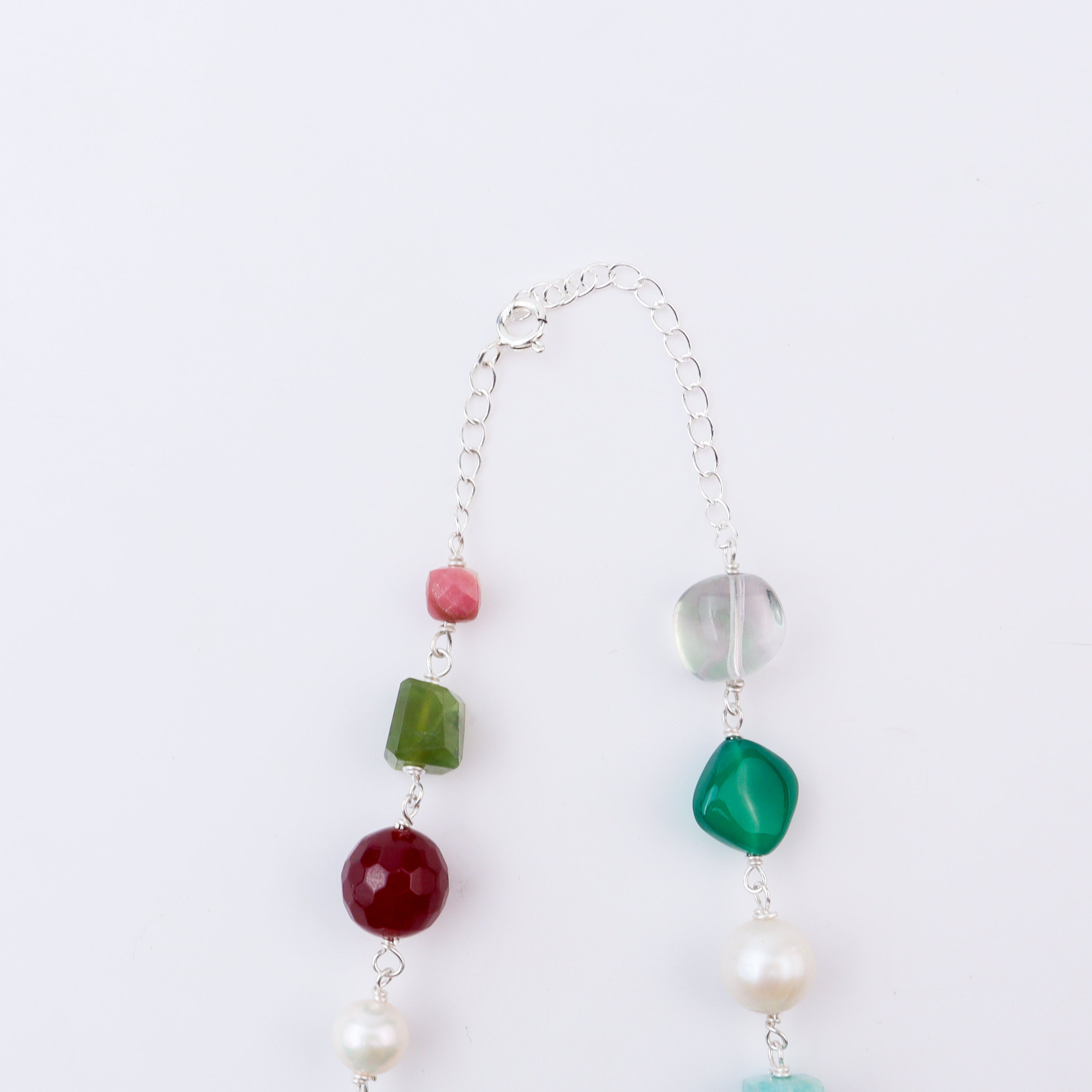 Close-up of necklace with multicolour stones