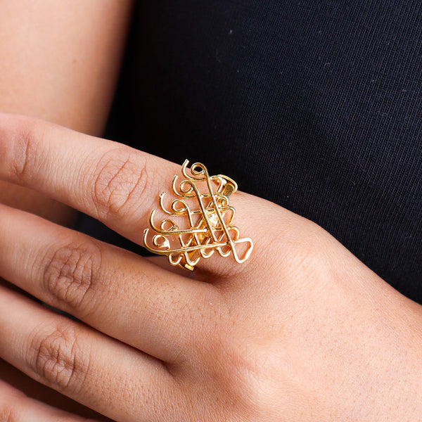 Close-up of gold plated Saraswati ring on finger