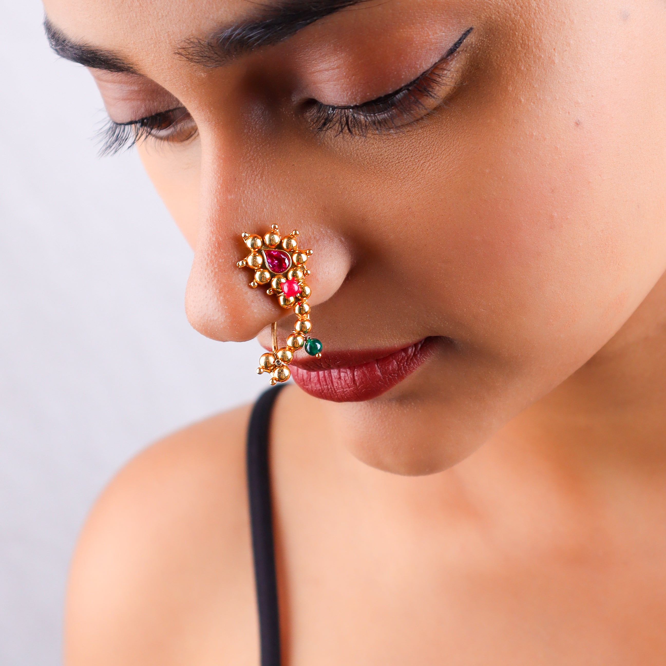 Close-up of woman's face with Nath jewelry on nose