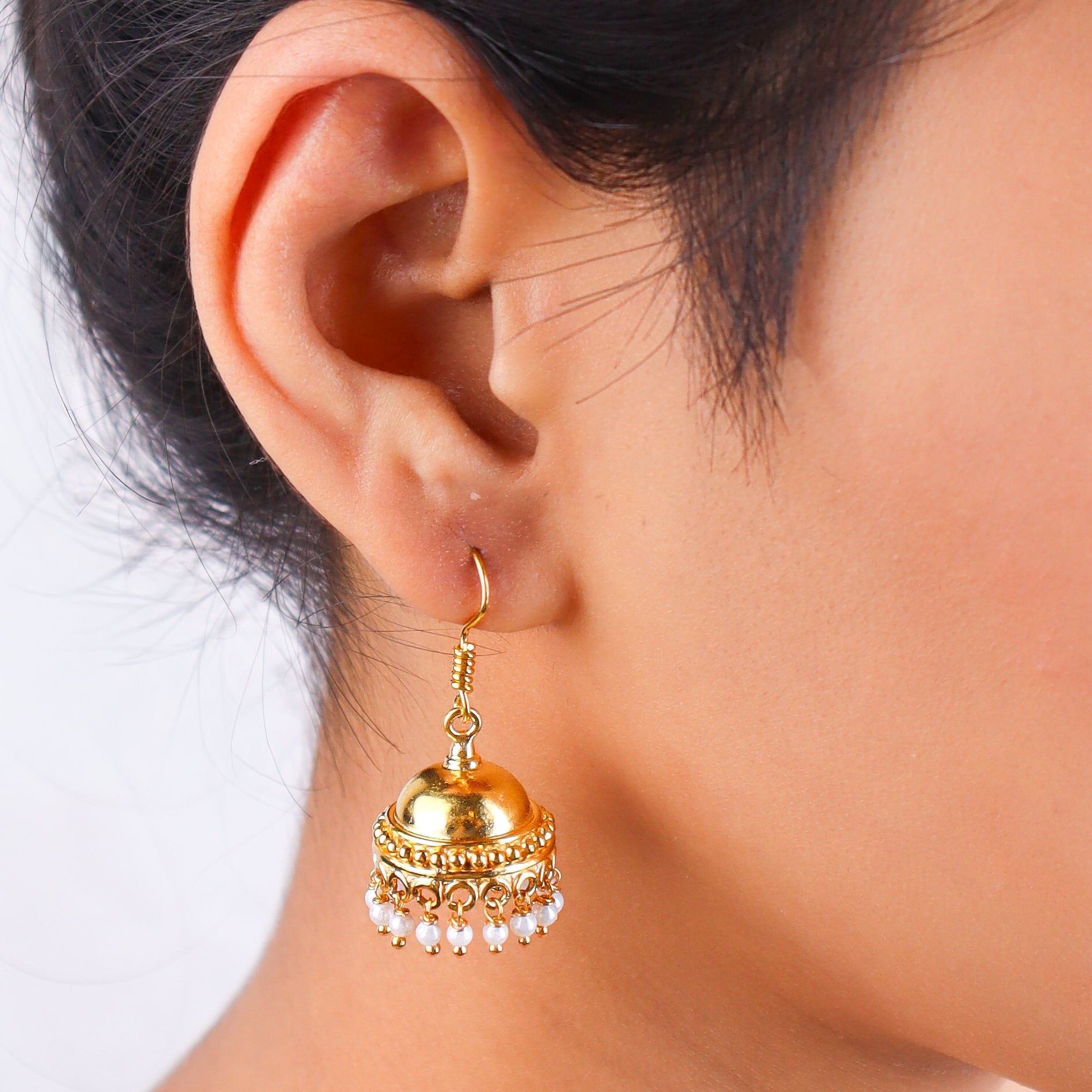 Close-up of gold earrings on white background