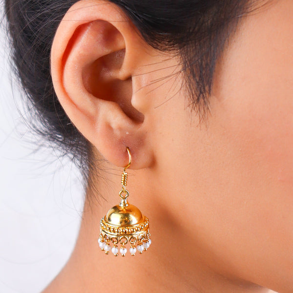 Close-up of gold earrings on white background