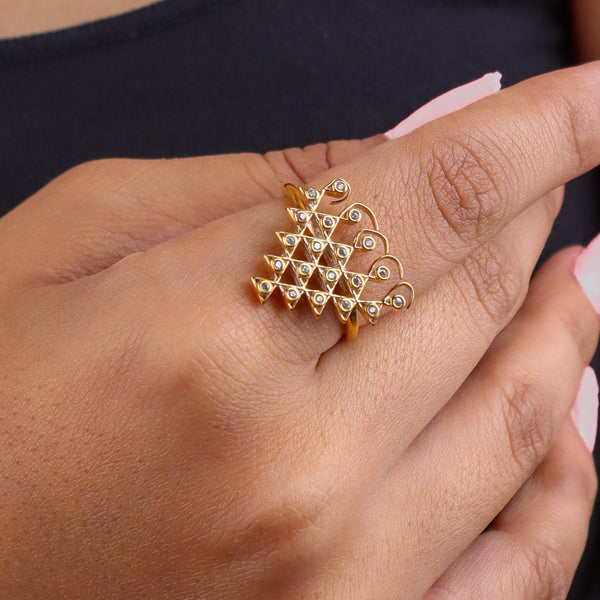 Close-up of gold plated silver Saraswati ring on finger