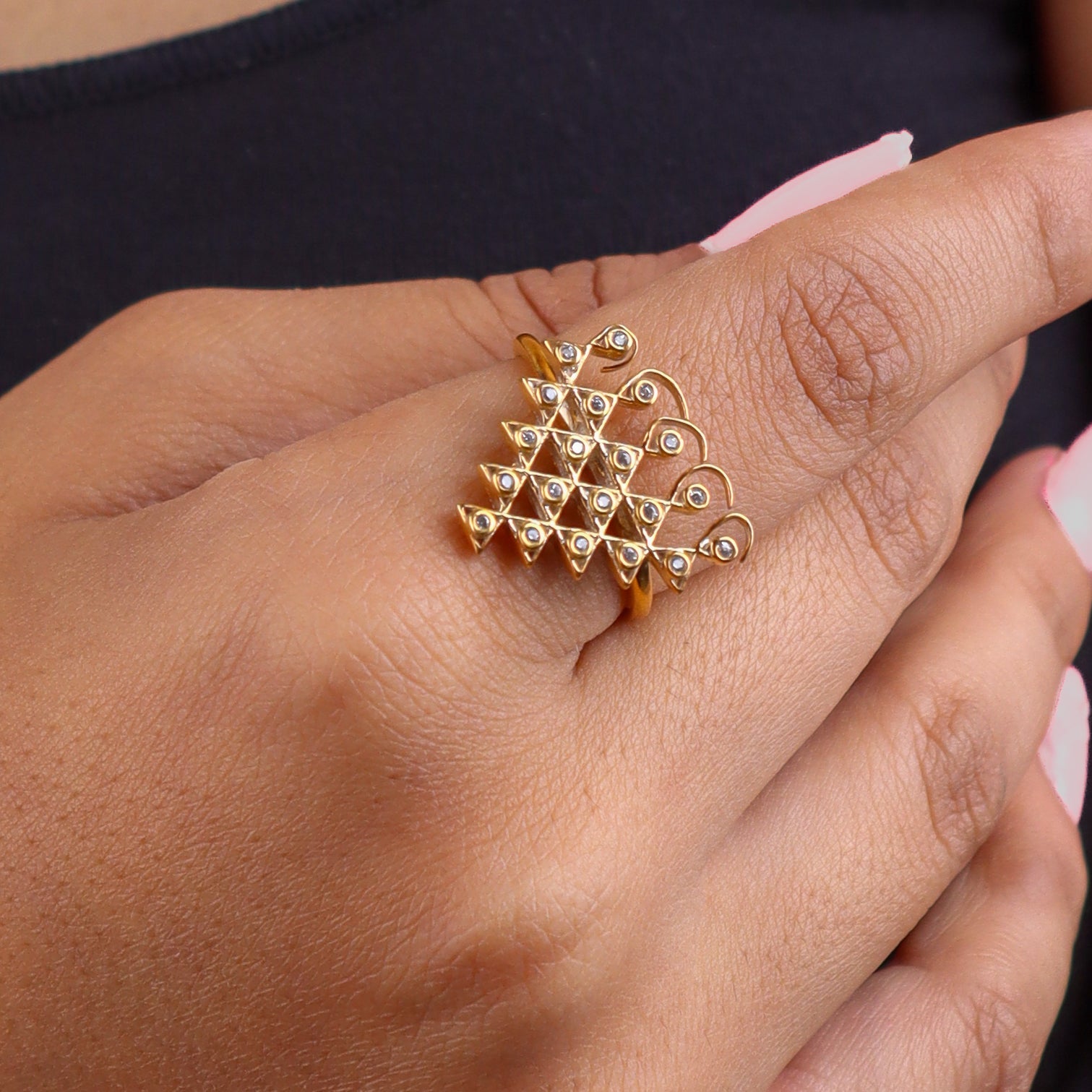 Close-up of gold plated silver Saraswati ring on finger