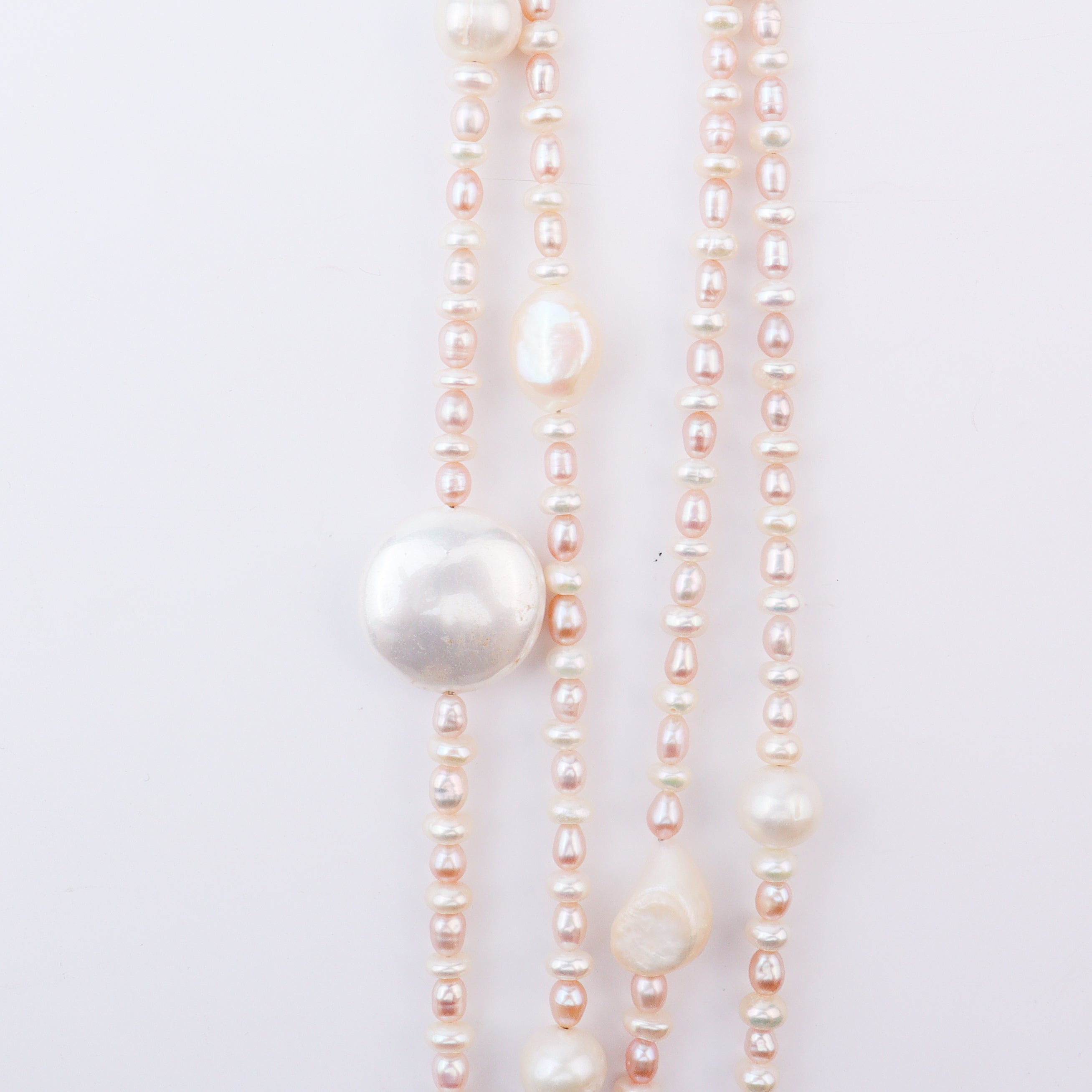 Close-up of pink and white pearl necklaces