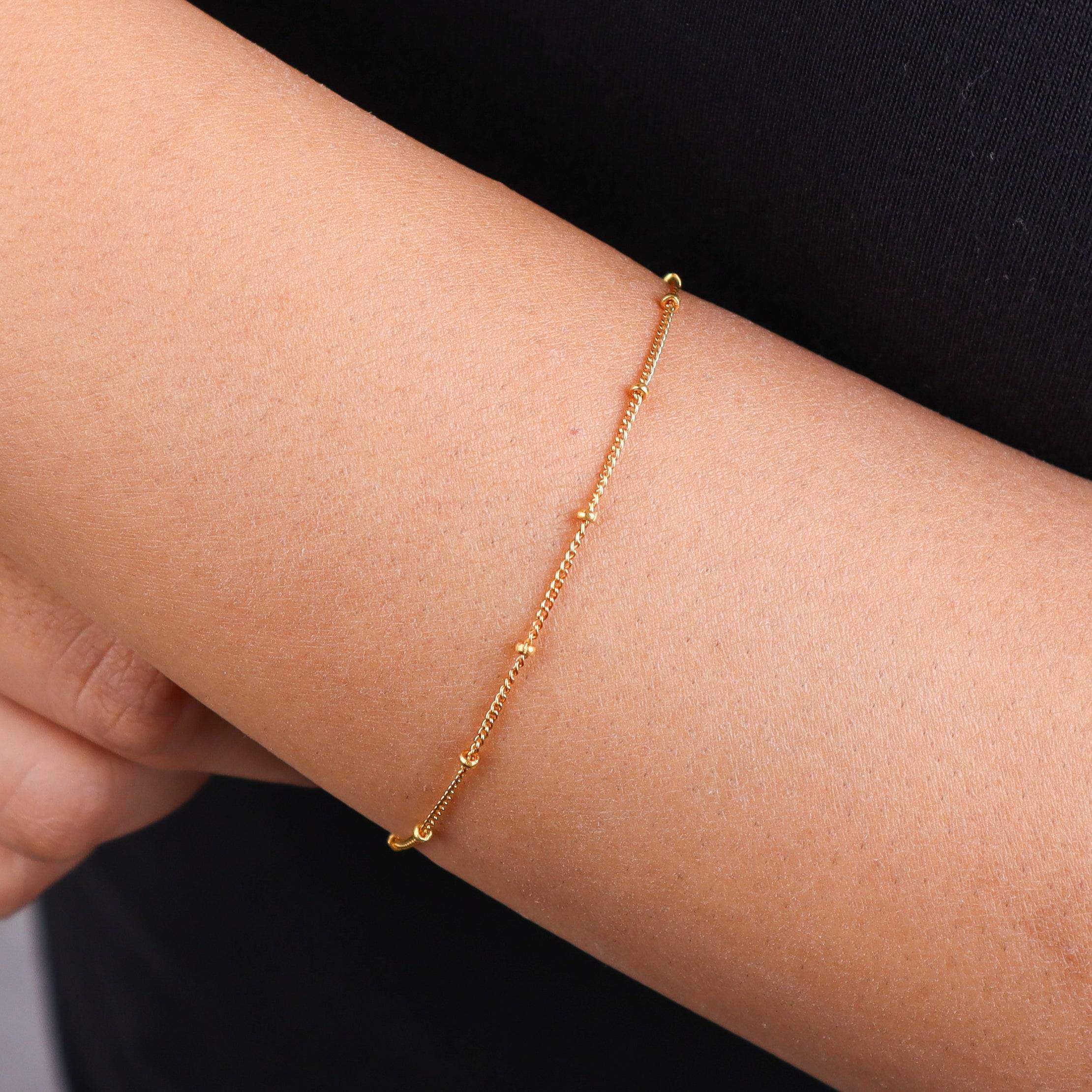 Close-up of gold chain bracelet on wrist