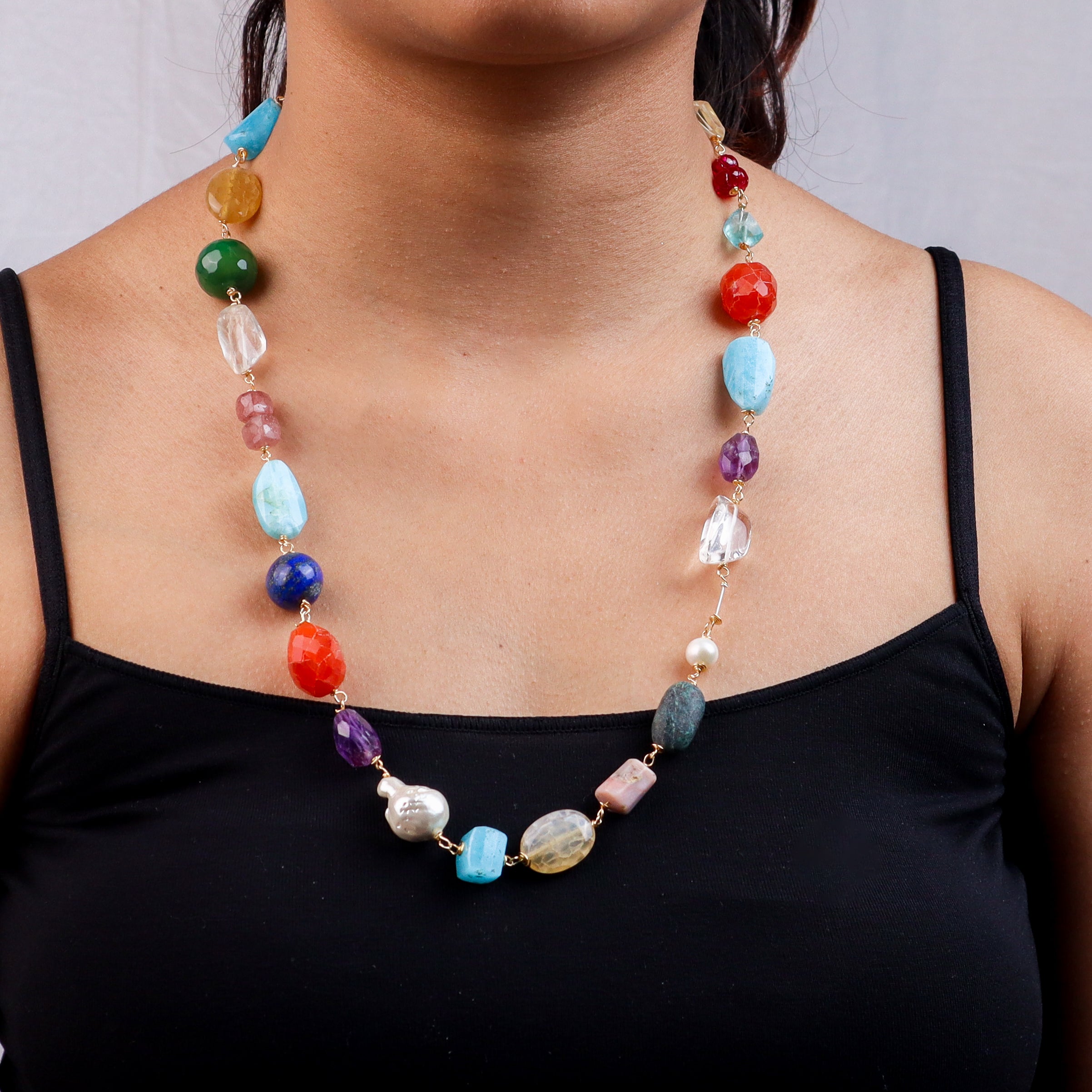 Close-up of multicolour stone necklace on model's neck