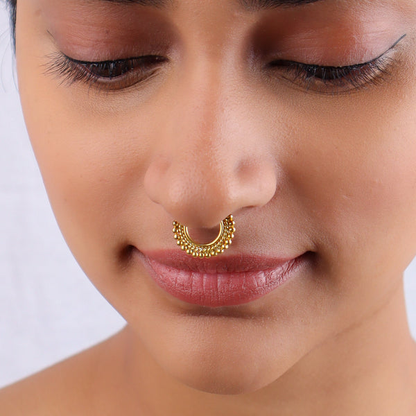 Close-up of woman wearing gold nose ring