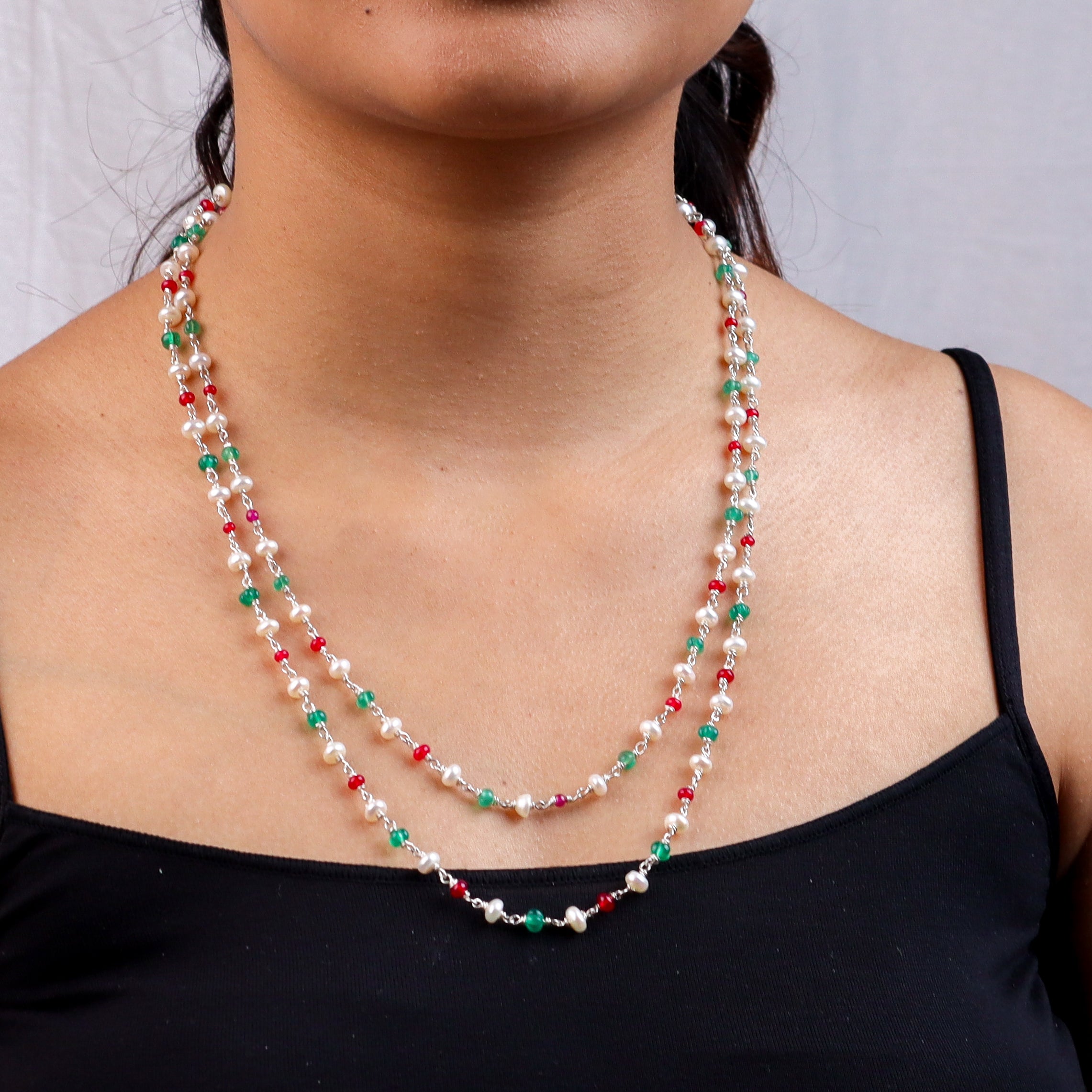 Elegant pearl and gemstone necklace worn by a model for jewelry fashion